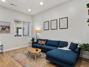Living area featuring wood finished floors and recessed lighting