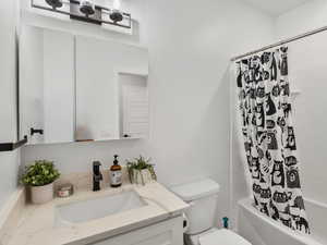Full bathroom with vanity and shower / bath combo with shower curtain