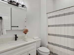 Full bath with vanity and a shower with shower curtain