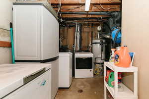 Below grade area featuring separate washer and dryer and secured water heater