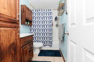 Full bathroom featuring vanity, tile patterned flooring, and shower / tub combo