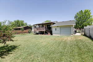 Back of house with stairs and a deck