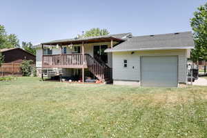 Back of house with stairway, a wooden deck, and roof with shingles