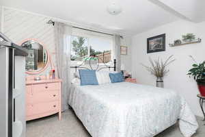 Bedroom with light carpet and access to outside