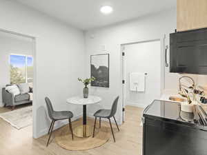 Dining room featuring light wood-type flooring and recessed lighting