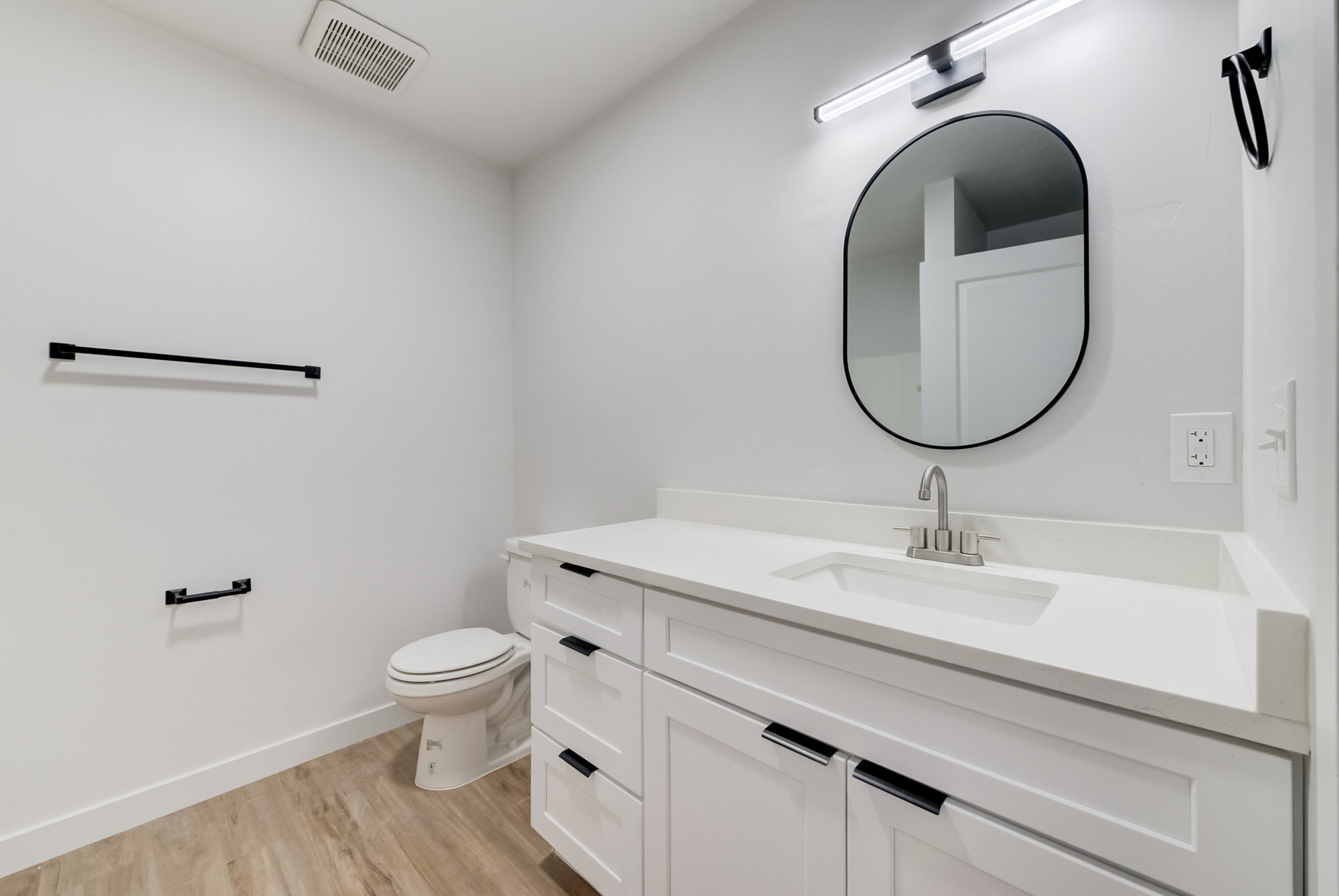 Bathroom featuring vanity and wood finished floors