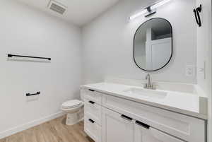 Bathroom featuring vanity and wood finished floors