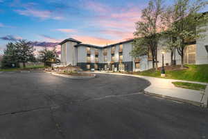 View of property at dusk