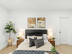 Bedroom featuring wood finished floors and baseboards