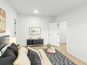 Living area with light wood-style floors and baseboards