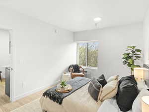 Bedroom with light wood-type flooring and baseboards
