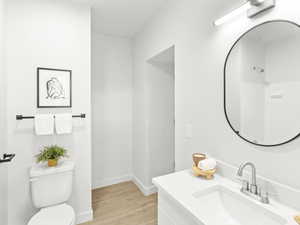 Full bathroom with vanity and wood finished floors
