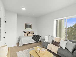 Bedroom featuring wood finished floors and baseboards