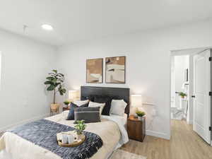 Bedroom featuring baseboards and wood finished floors