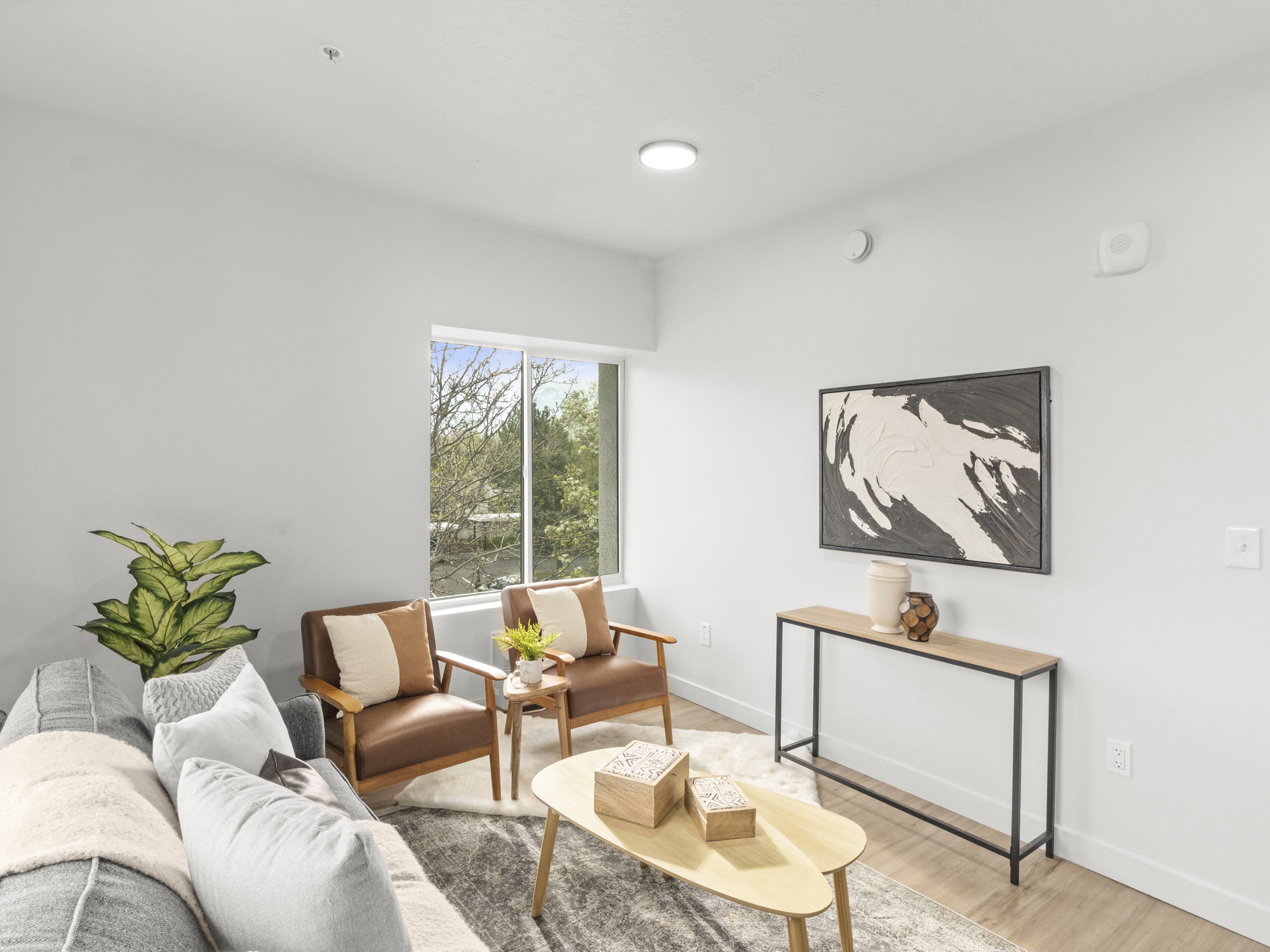 Living area featuring light wood-style floors and baseboards