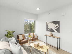 Living area featuring light wood-style floors and baseboards