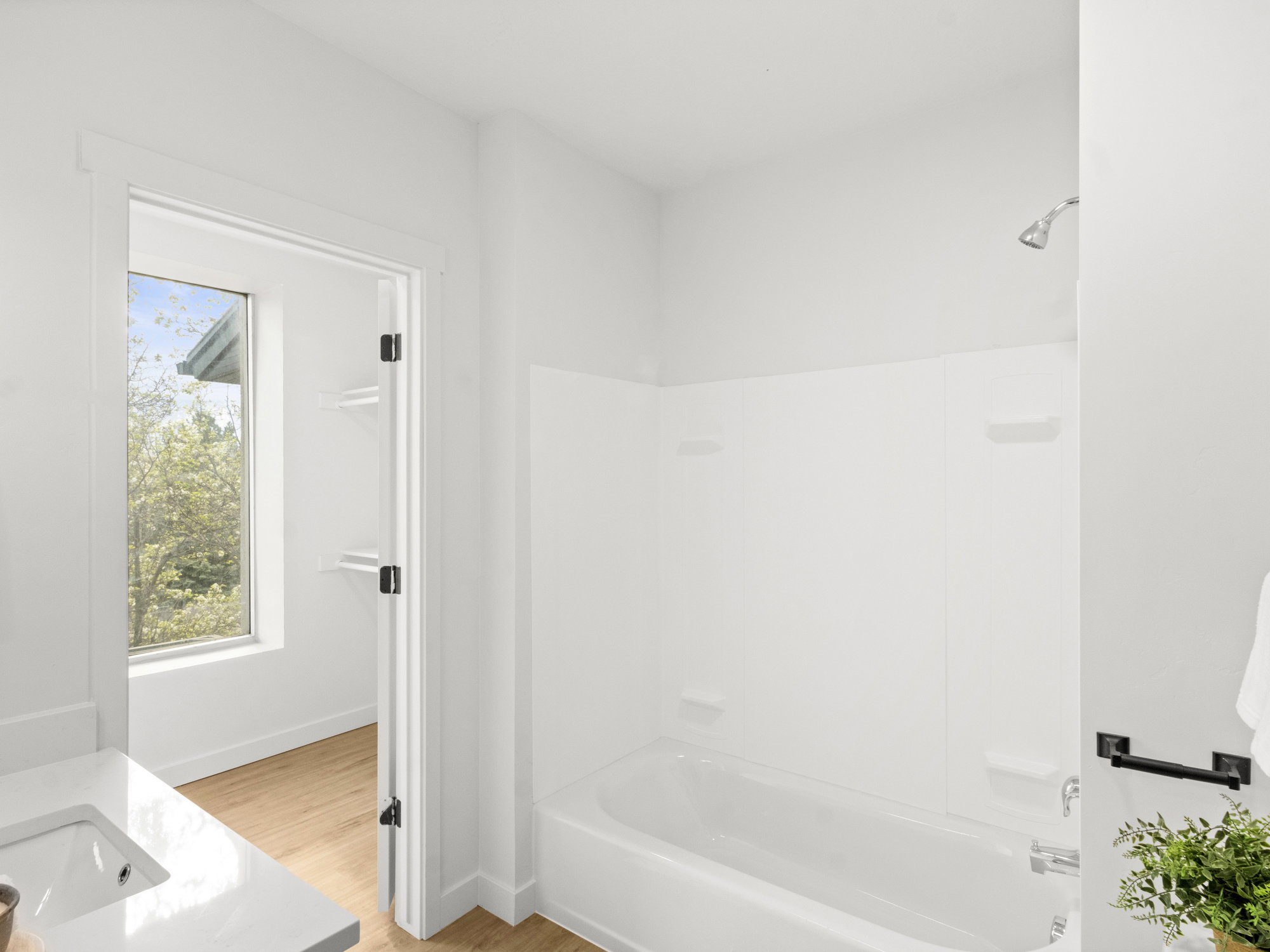 Full bath featuring bathing tub / shower combination, wood finished floors, and vanity