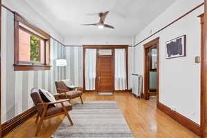 Entrance foyer with radiator, light wood-type flooring, and ceiling fan