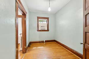 Unfurnished room with light wood-style floors and cooling unit