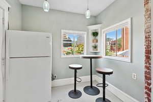 Kitchen with freestanding refrigerator and healthy amount of natural light