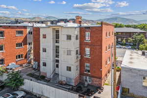 View of apartment building / complex featuring a mountain view and cooling unit
