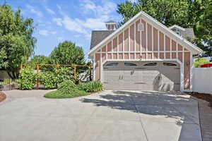 Garage featuring concrete driveway