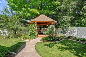 Fenced backyard with a gazebo