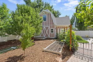 View of outbuilding with a gate