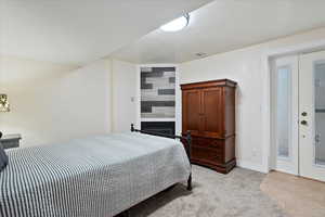 Bedroom featuring baseboards and a large fireplace