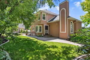 Rear view of property featuring stucco siding and roof with shingles
