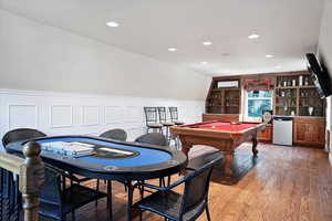 Game room with billiards, wainscoting, a dry bar, a wall mounted AC, and light wood-type flooring
