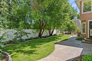 Fenced backyard featuring a patio