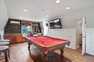 Playroom with a wainscoted wall, light wood finished floors, billiards table, an AC wall unit, and recessed lighting