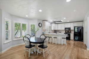 Dining room featuring light wood-style floors and recessed lighting