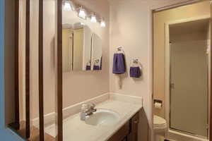 Full bath with vanity and a shower stall
