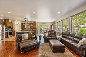 Living area with wood-type flooring and recessed lighting