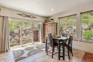 Dining area with plenty of natural light, light tile patterned flooring, and recessed lighting