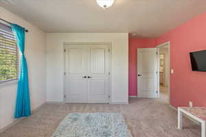 Unfurnished bedroom featuring carpet floors and a closet