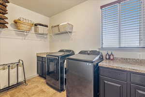 Washroom with washing machine and clothes dryer and cabinet space