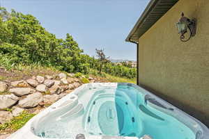 View of swimming pool featuring a hot tub