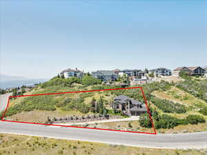 Aerial perspective of suburban area featuring property boundaries highlighted