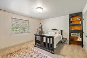 Carpeted bedroom with baseboards