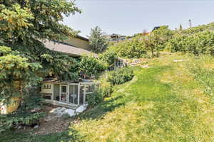 View of green lawn featuring exterior structure
