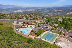 Aerial view of property's location featuring a mountainous background and nearby suburban area