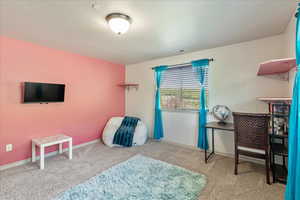 Carpeted bedroom featuring baseboards