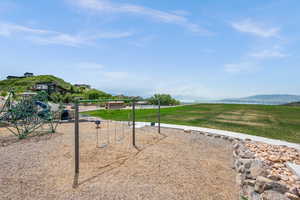Surrounding community featuring a lawn and a mountain view