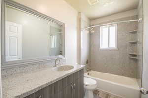 Full bath featuring vanity, shower / bath combination, and wood finished floors