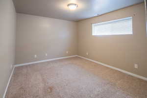 Spare room featuring carpet
