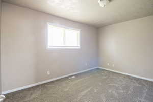 Carpeted empty room with baseboards