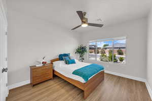 Bedroom featuring light wood finished floors and a ceiling fan